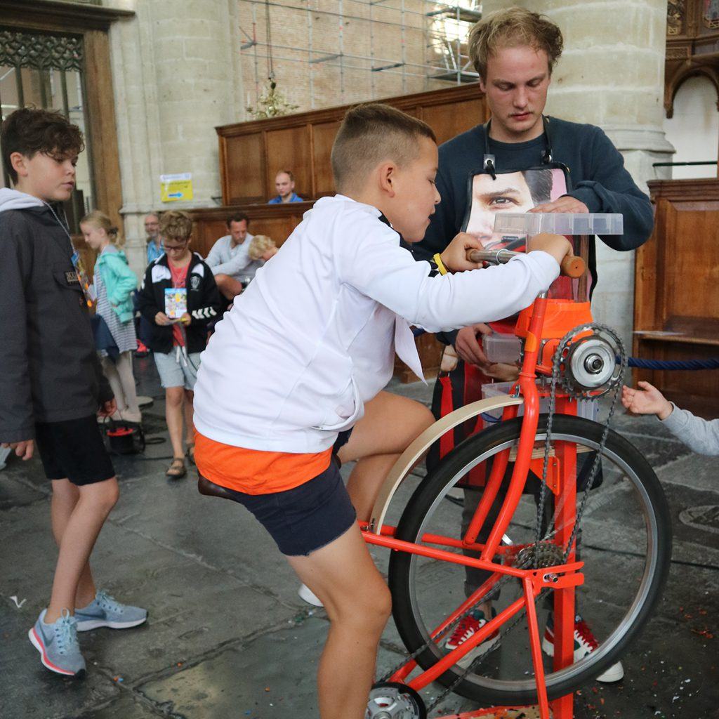 Al fietsend plastic vermalen tijdens de jeugdafvalmarathon in de Grote Kerk